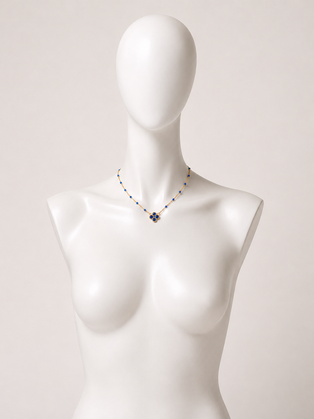 Collana dorata con fiore e cristalli blu