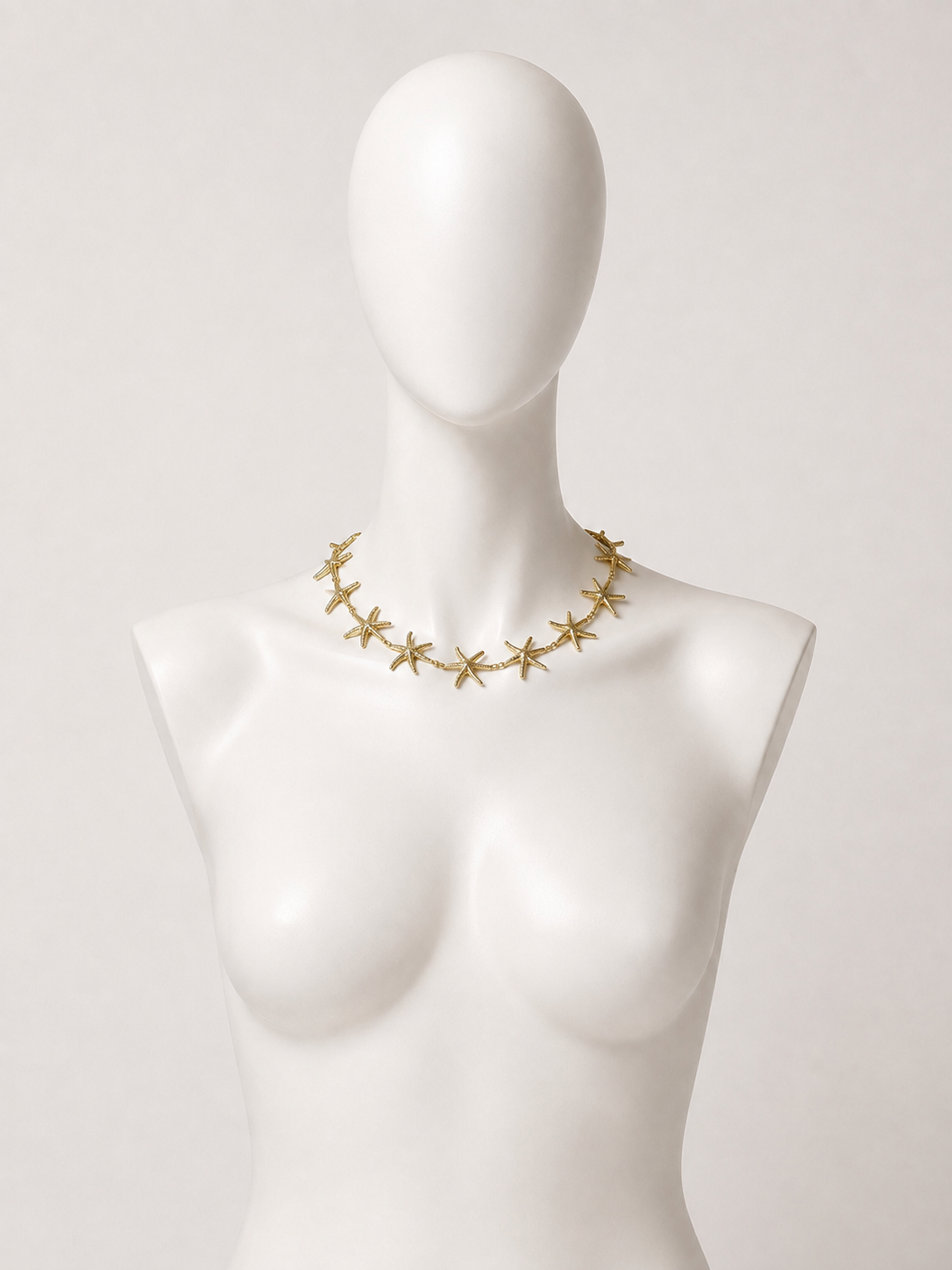 Collana girocollo dorata con stelle marine
