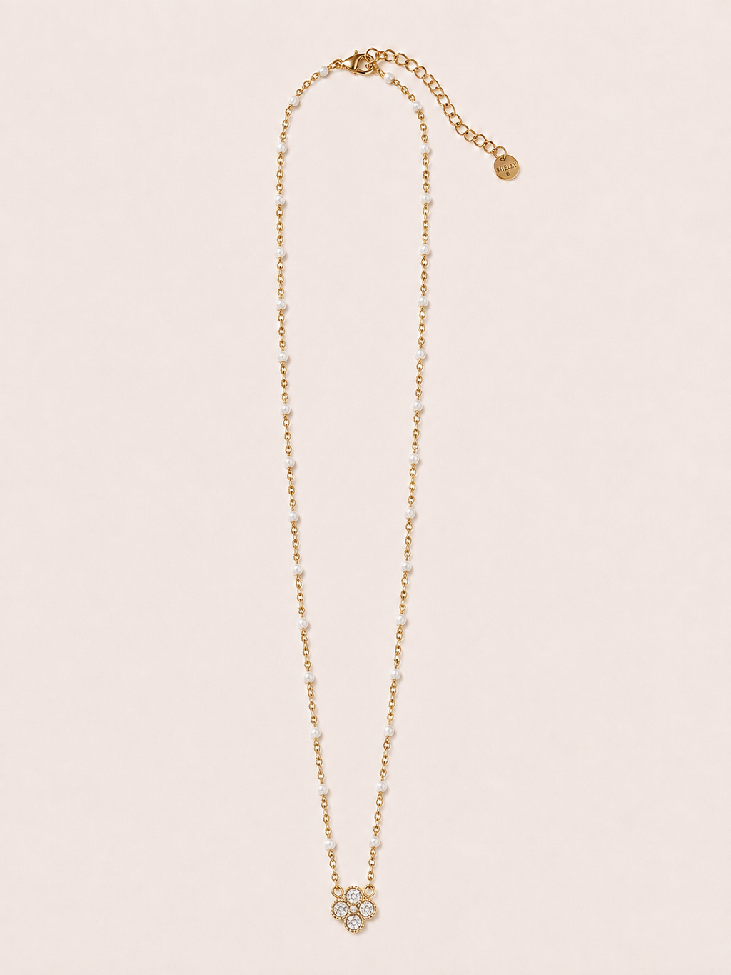 Collana dorata con fiore, cristalli e dettagli bianchi