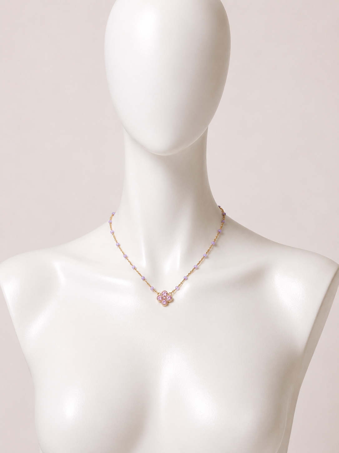 Collana dorata con fiore e cristalli lilla